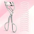 Silver stainless steel eyelash curler with 15 replacement pads on pink background